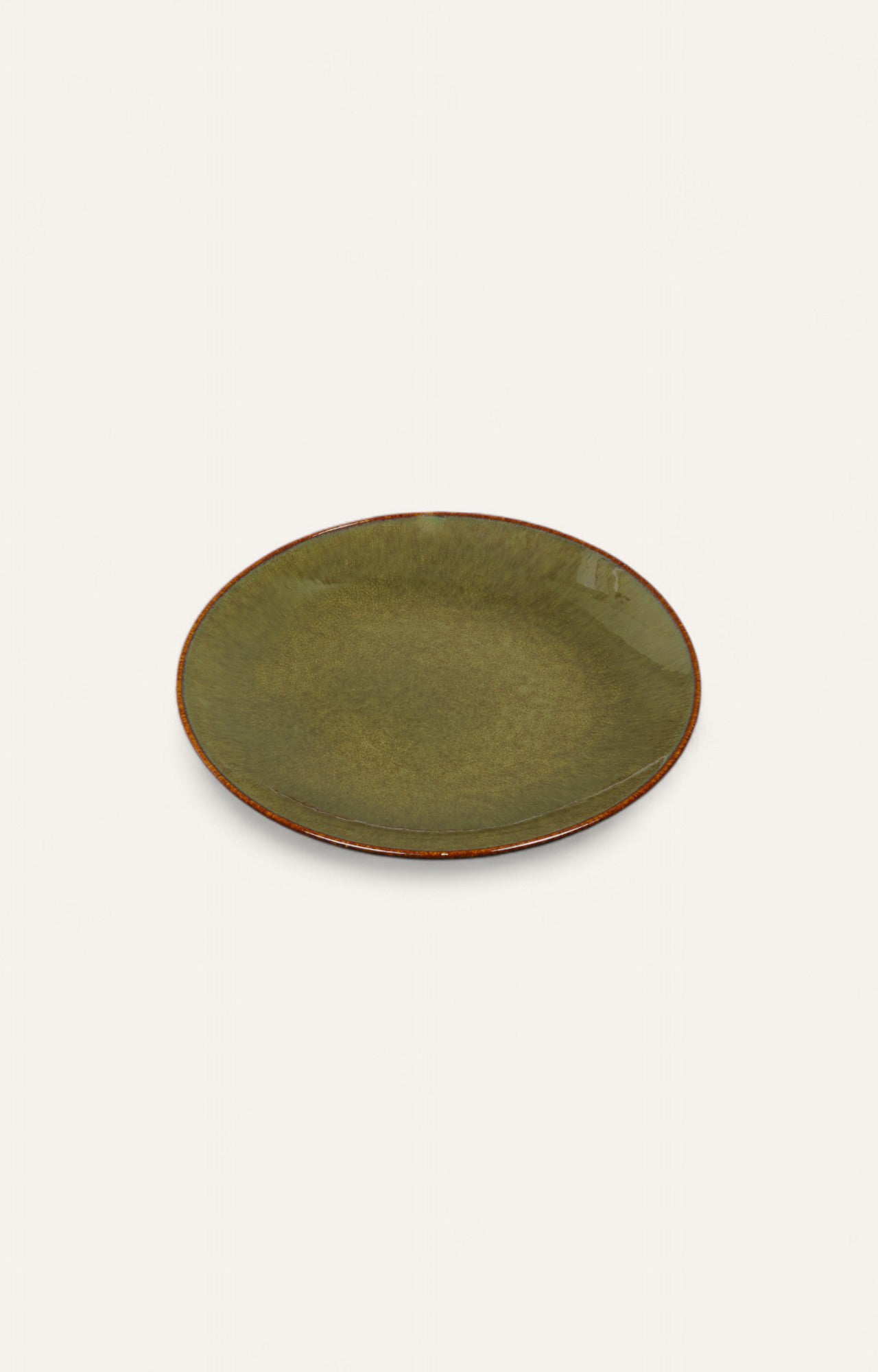 Round olive-green glazed ceramic plate with rust rim