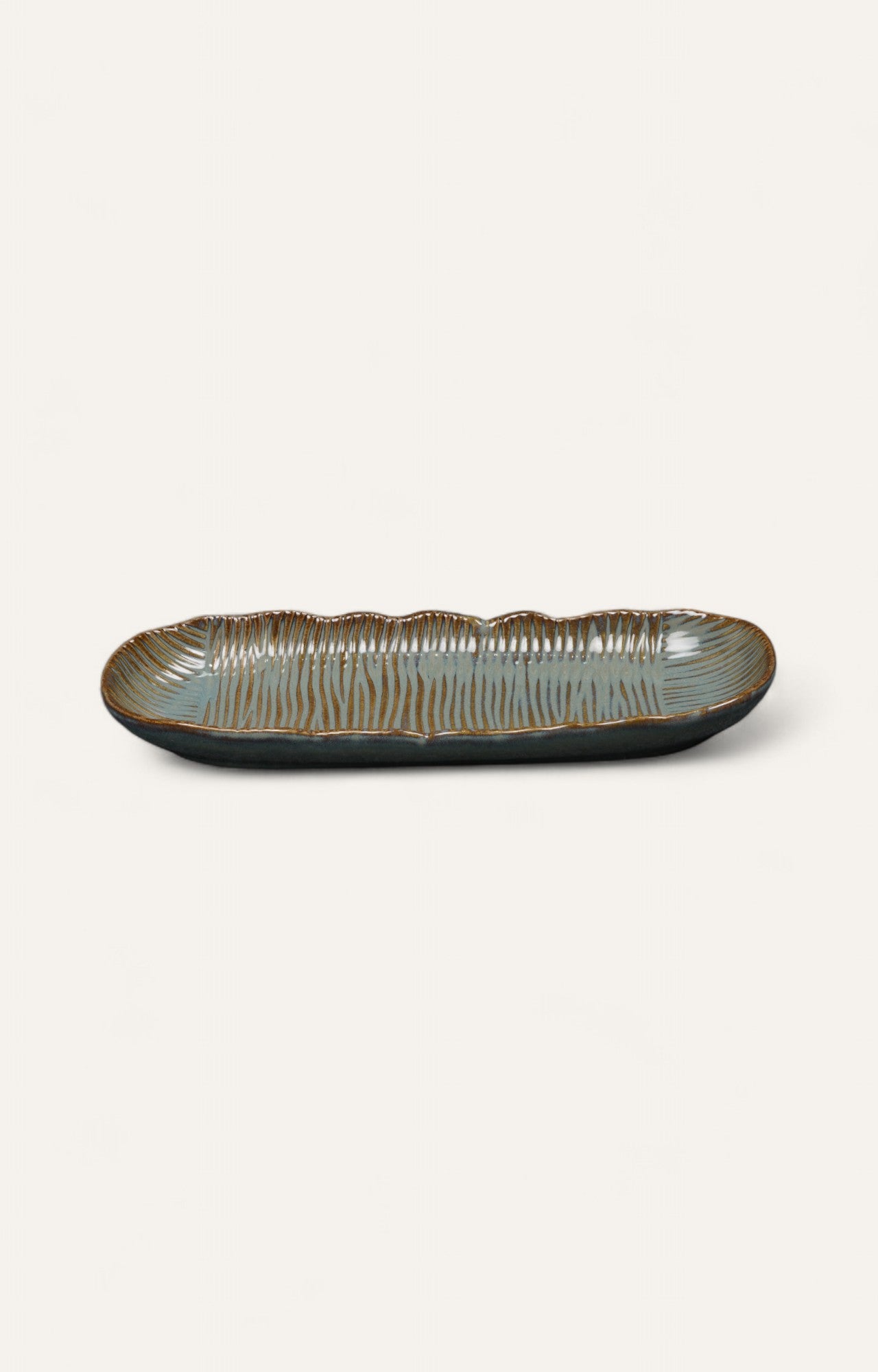Long glazed ceramic platter with ribbed texture and earthy tones
