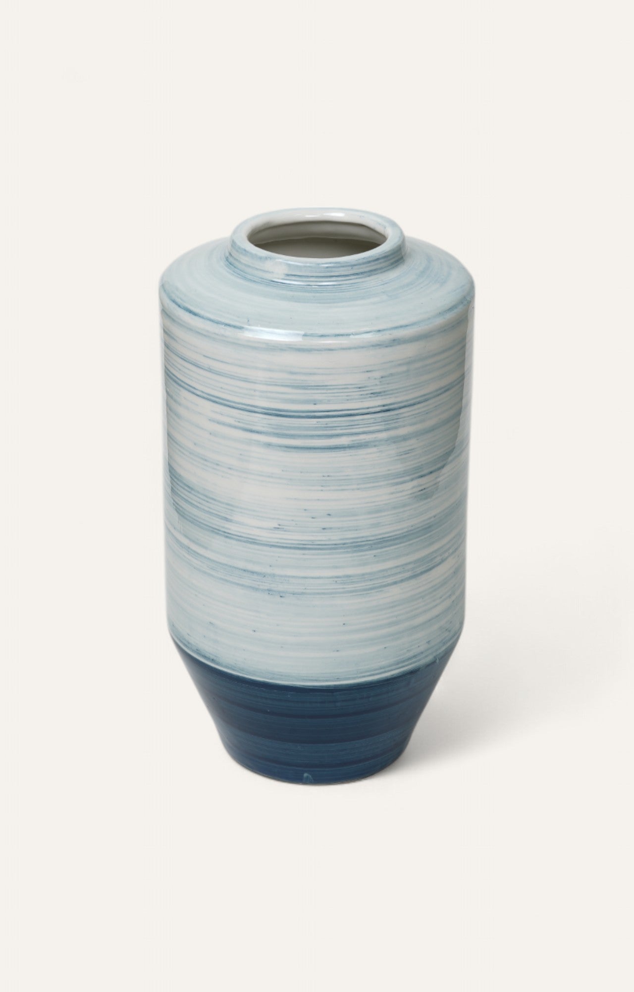 Tall ceramic vase with blue brushstroke glaze and gradient base