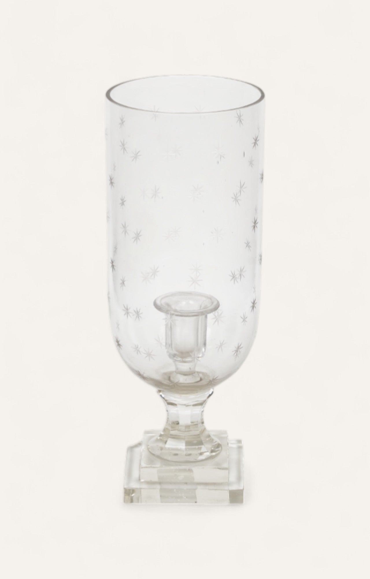 Star-patterned clear glass hurricane candle holder on square base