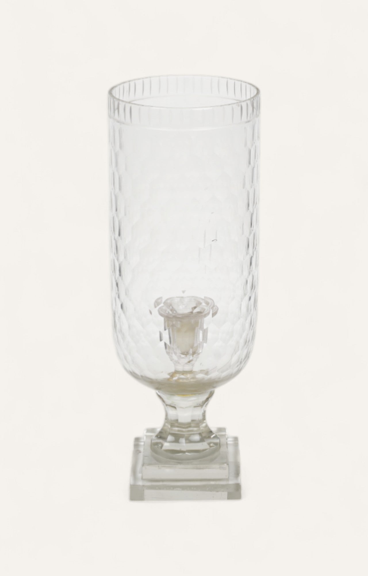 Tall ribbed glass hurricane candle stand on a layered base