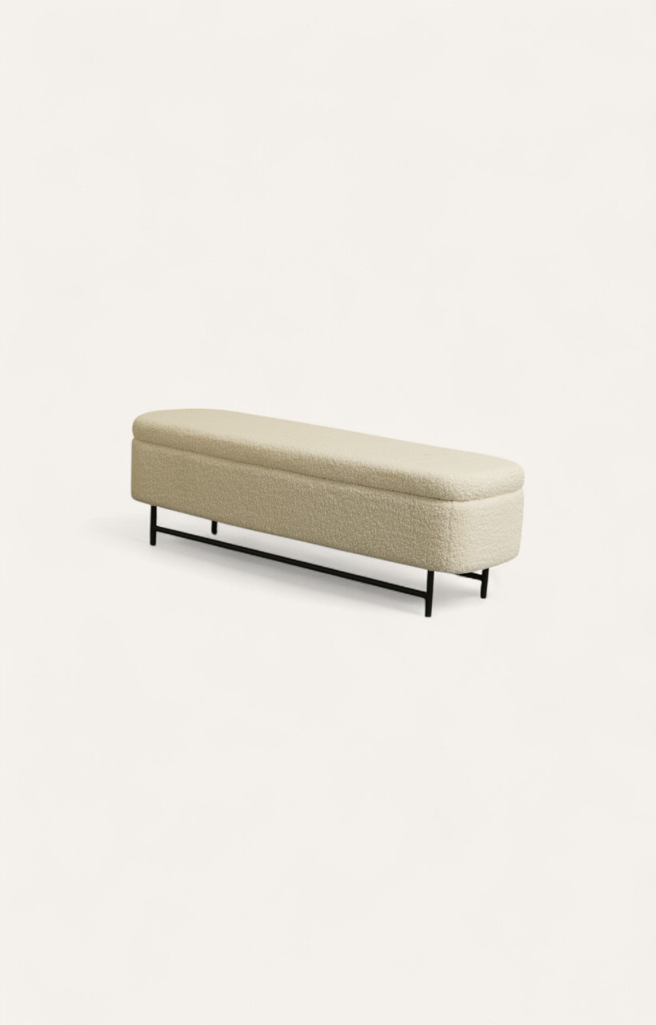 Long bench upholstered in soft off-white boucle fabric with slim dark steel legs.