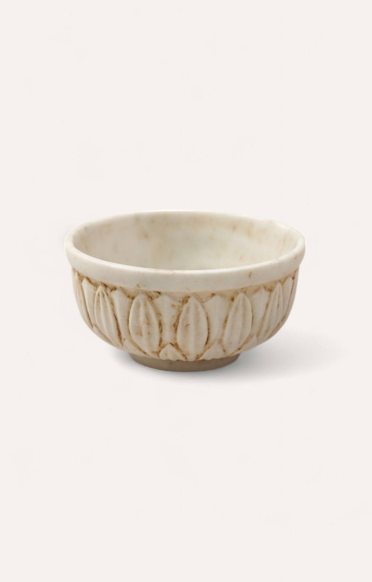 Low white marble bowl with carved floral motif
