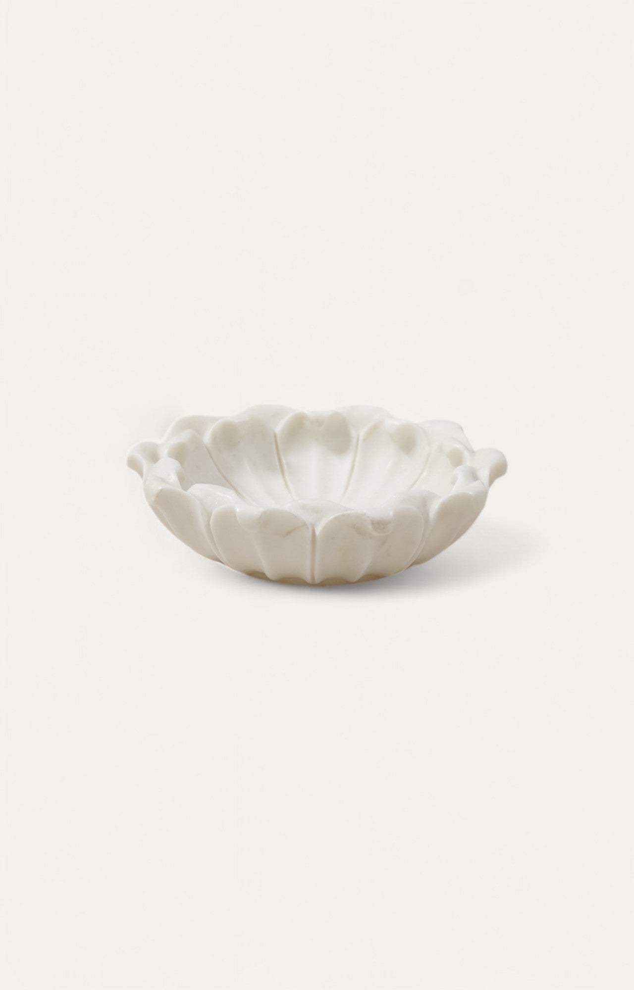 Scalloped white marble bowl with radial carved detailing