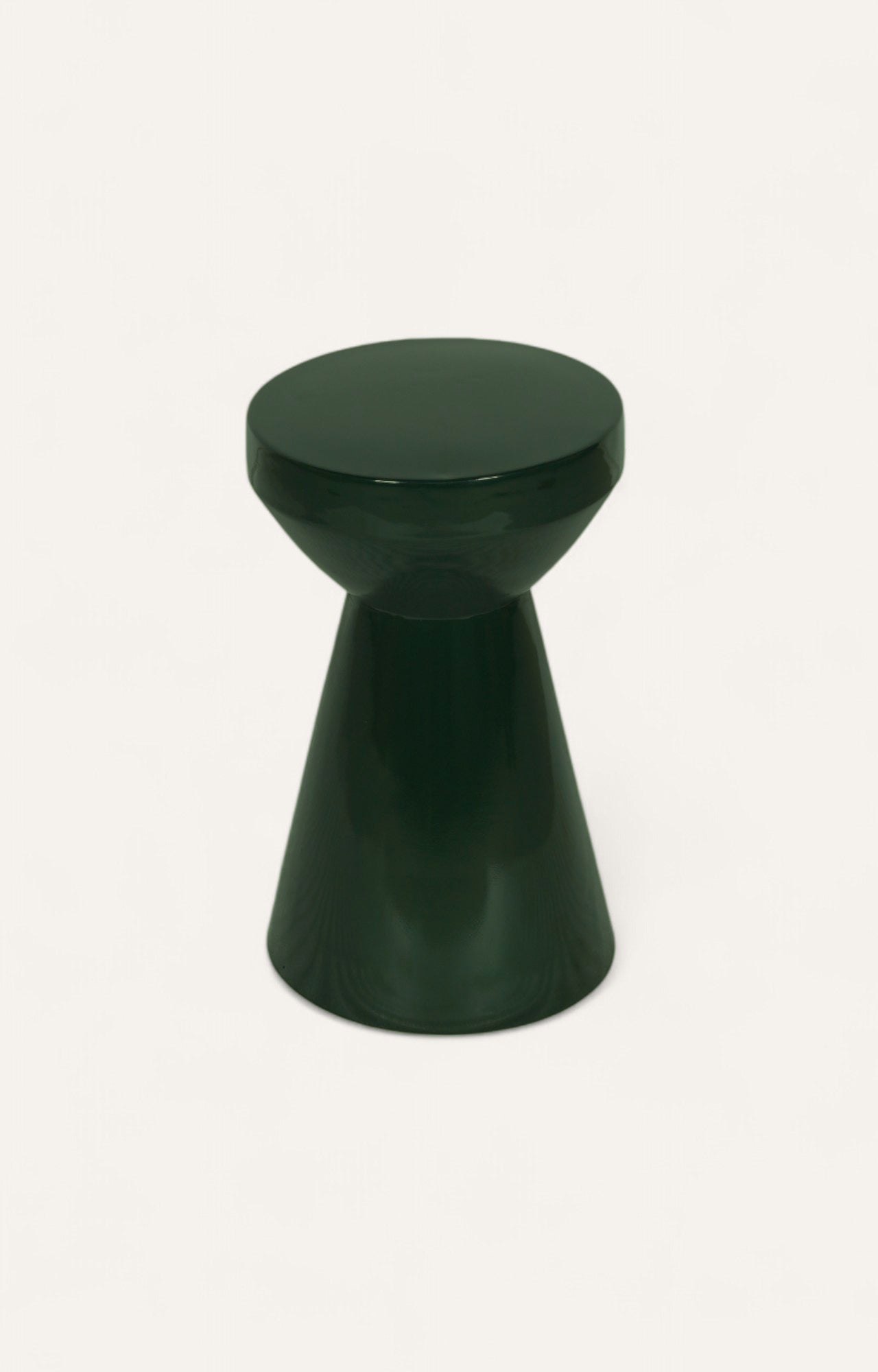 Dark green sculptural metal side table for multiple uses.