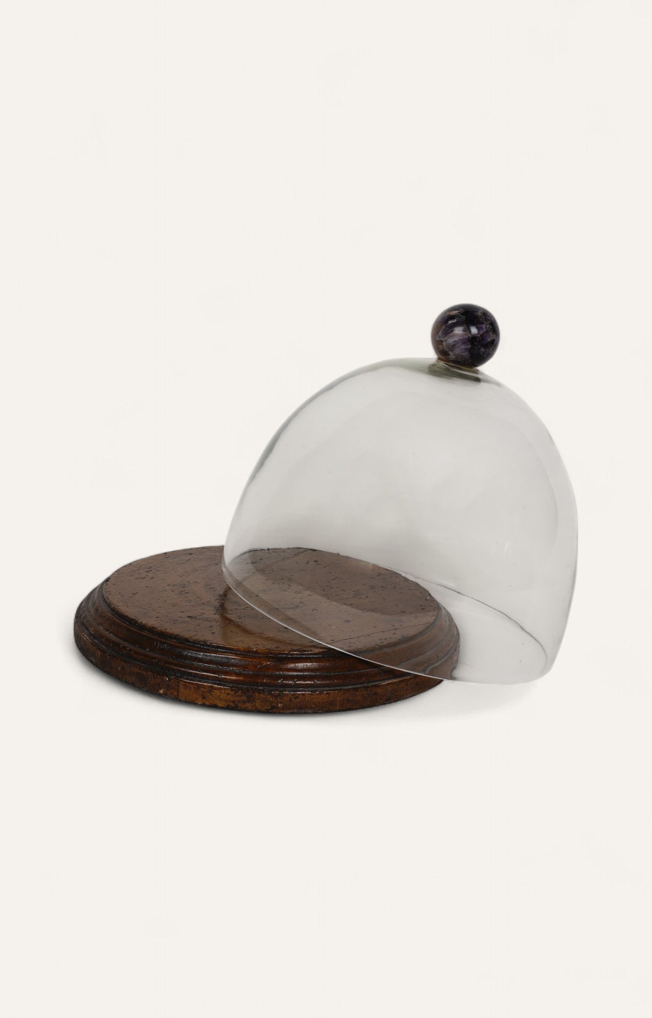 Glass cake cloche with amethyst finial and antique-finish mango wood base.