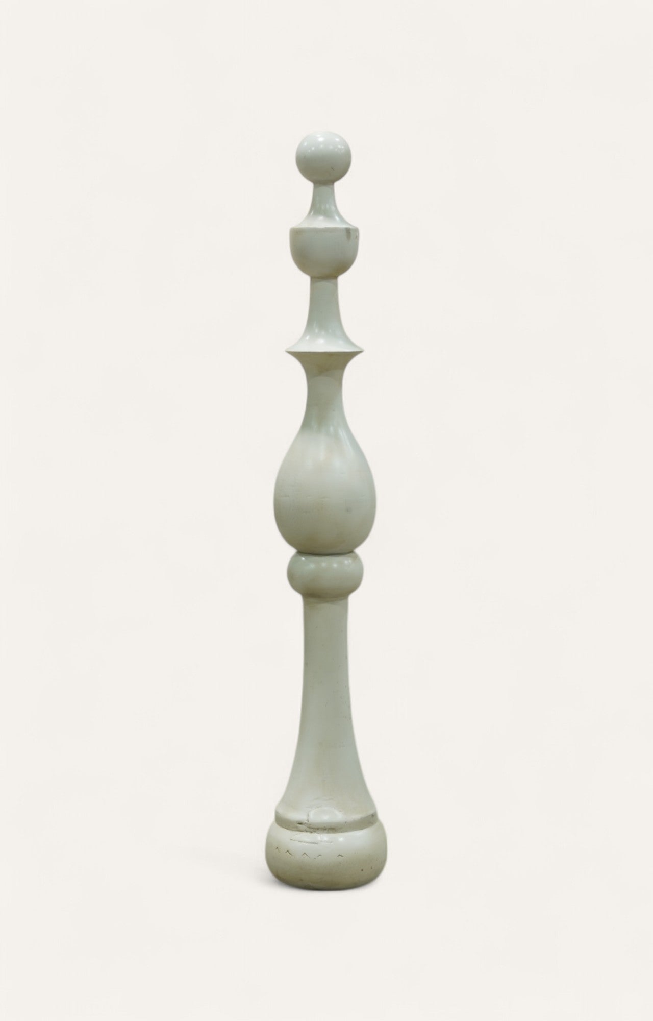 Tall sculptural pillar in whitewashed acacia wood with tiered geometric form.