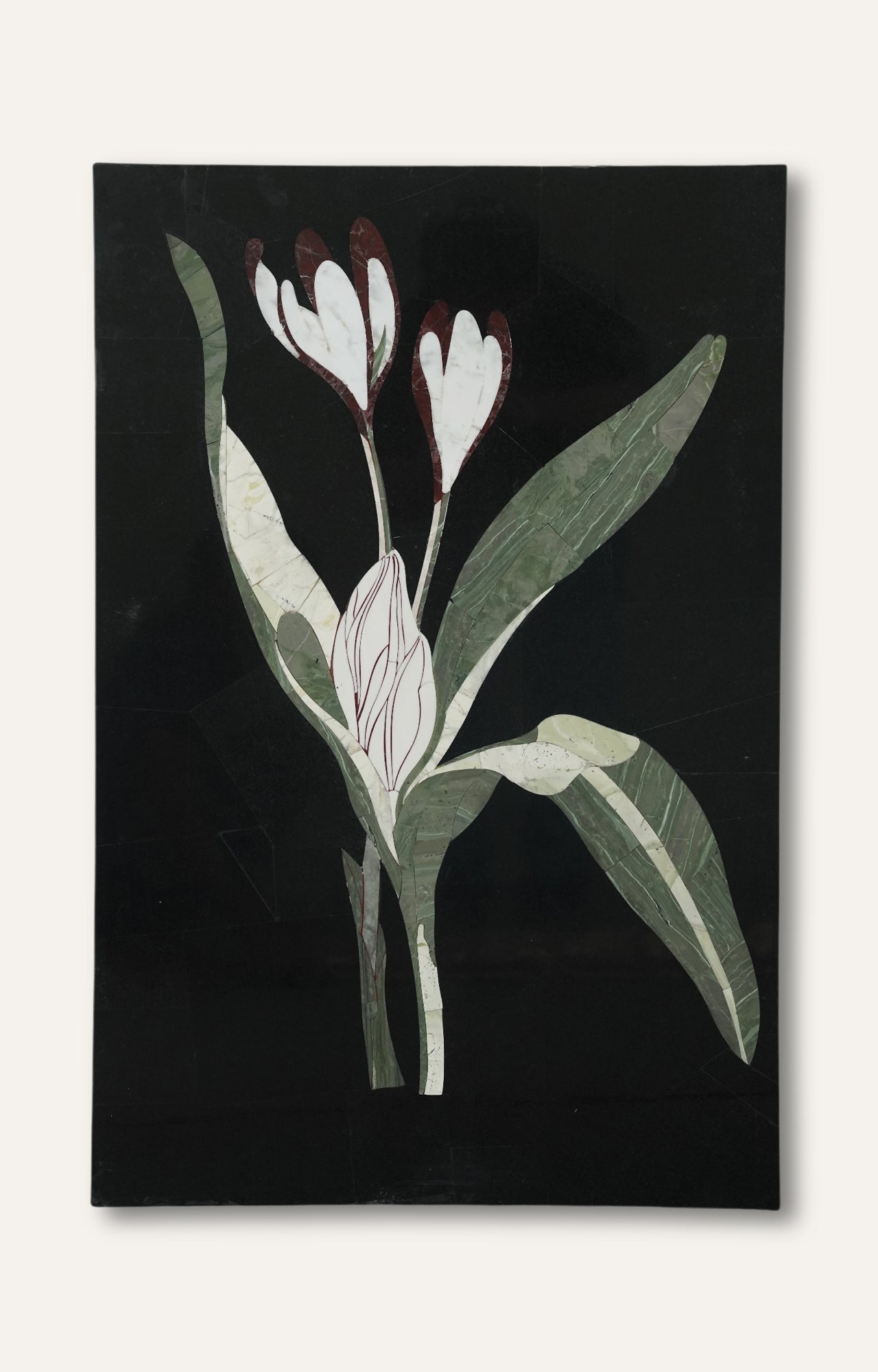 Botanical crocus flower inlay panel on polished black limestone with green and maroon highlights.