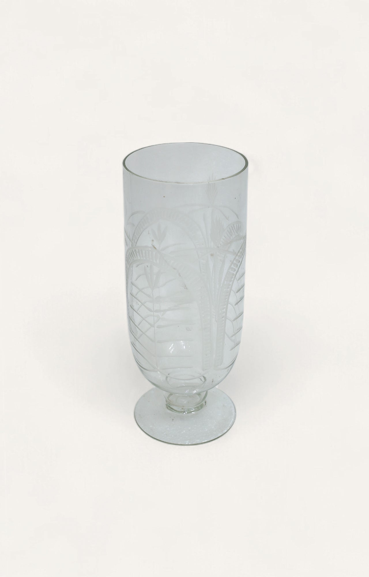 Clear glass candle stand with etched palm leaf design and pedestal base, 10.5 inches tall
