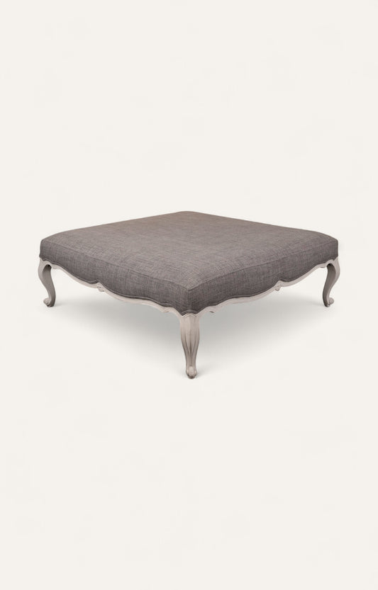 Elegant Gray Ottoman with Sculpted Wooden Legs