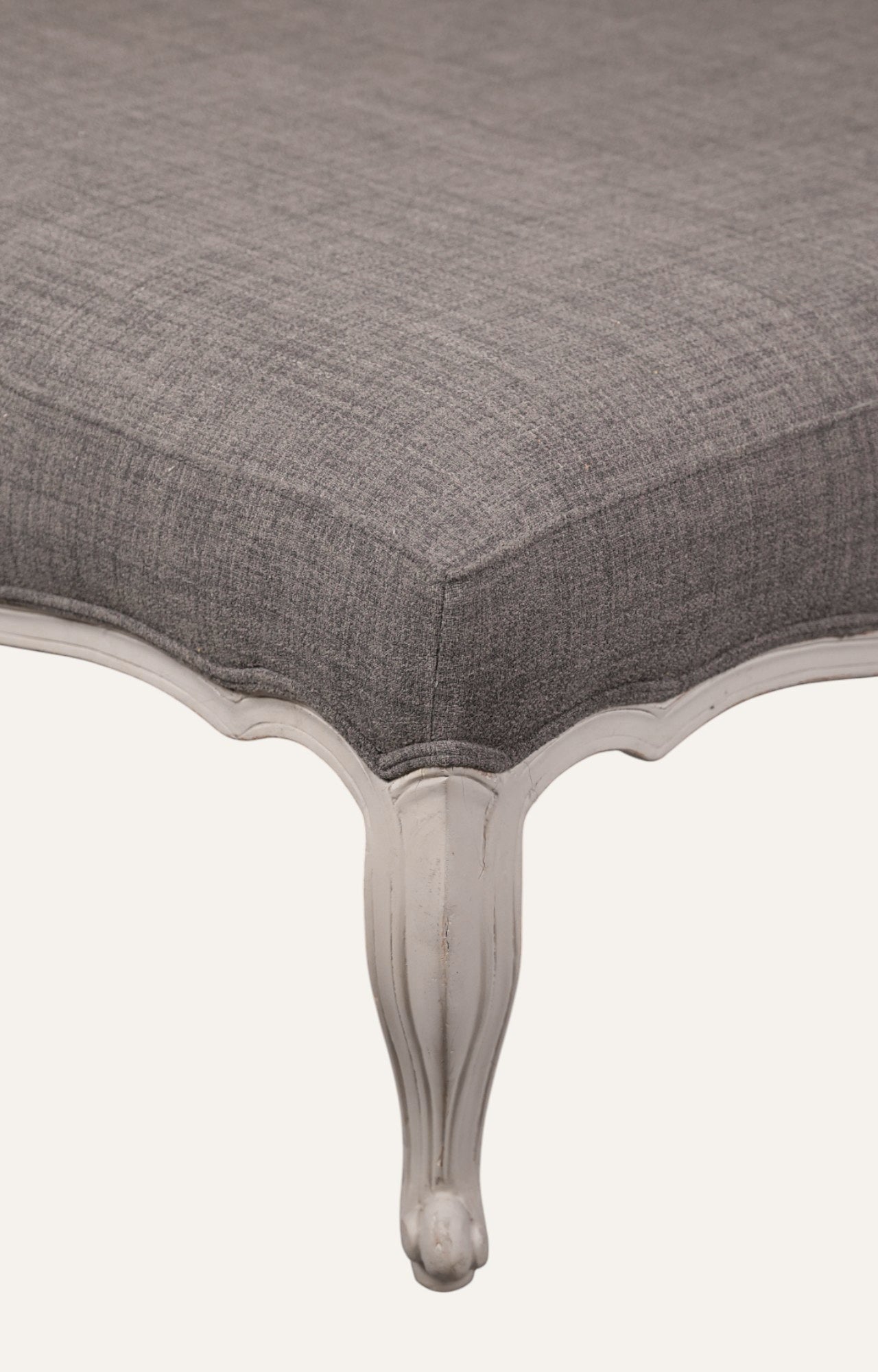 Elegant Gray Ottoman with Sculpted Wooden Legs