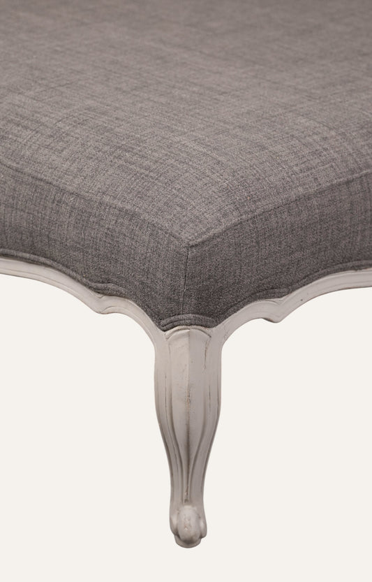 Elegant Gray Ottoman with Sculpted Wooden Legs