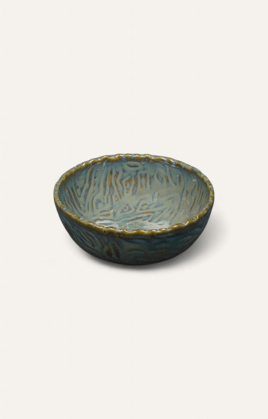 Large ceramic bowl with blue glaze and ripple-edge detail