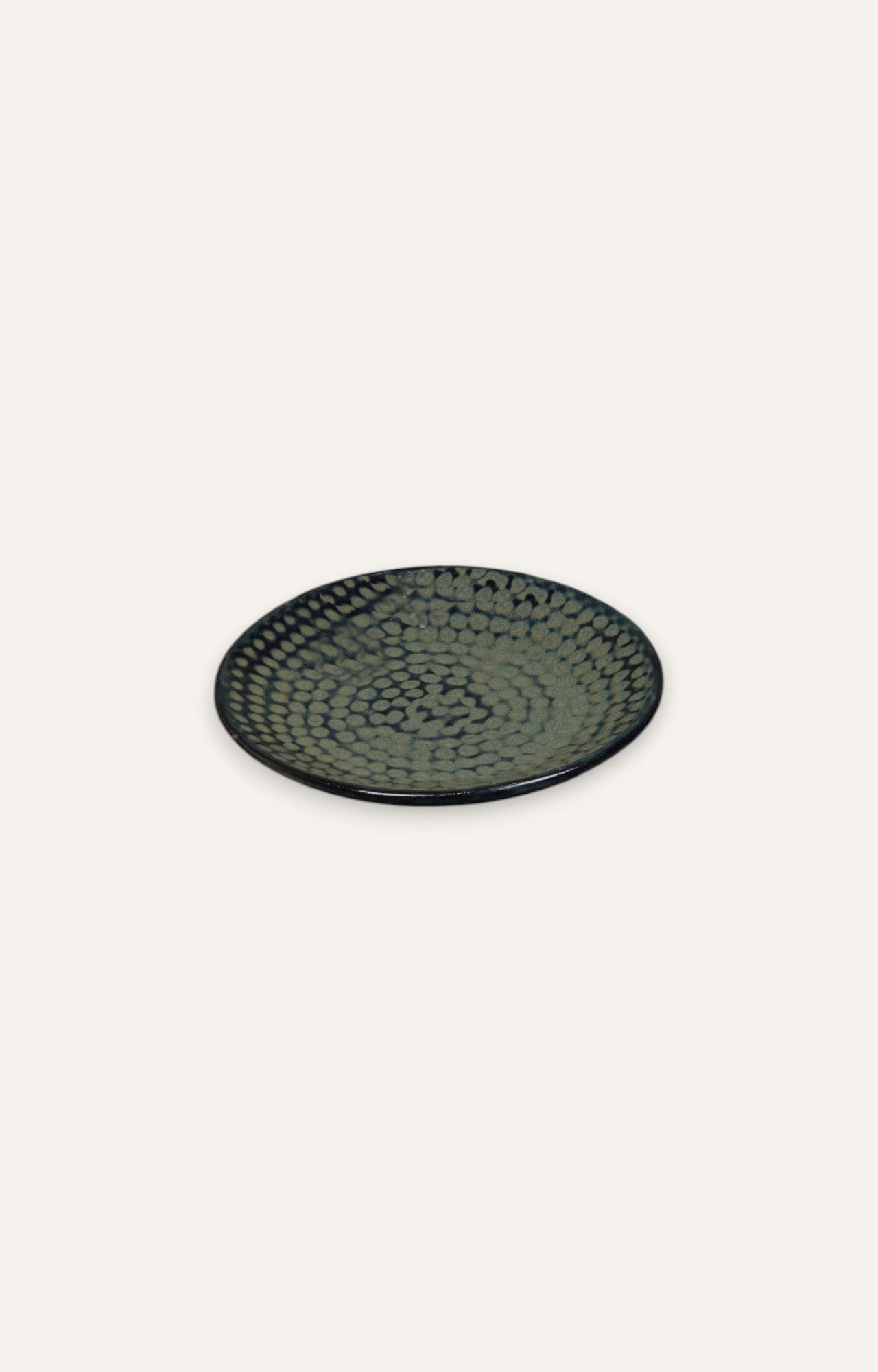 Round ceramic plate with black and olive honeycomb glazed finish
