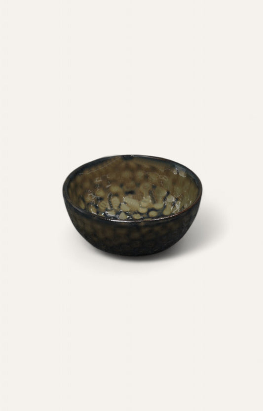 Dark pebble-patterned ceramic bowl with glazed finish