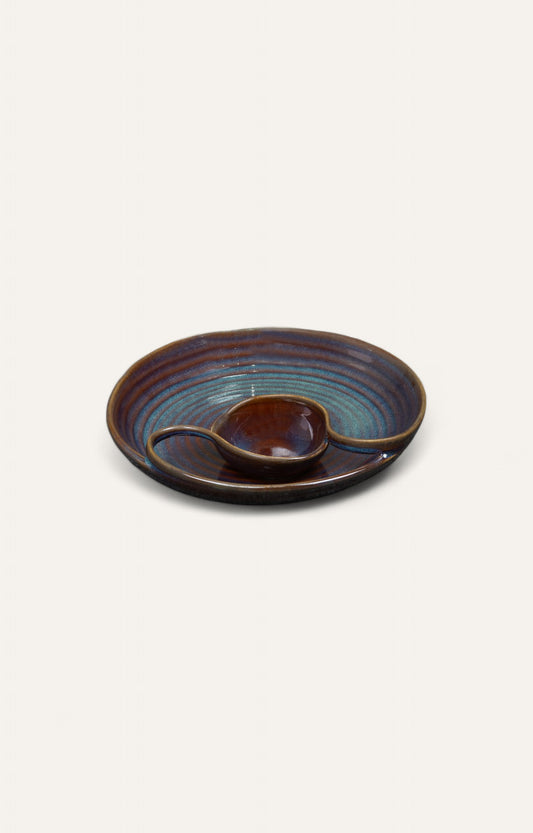 Circular ceramic chip and dip platter with built-in bowl and spiral glaze design