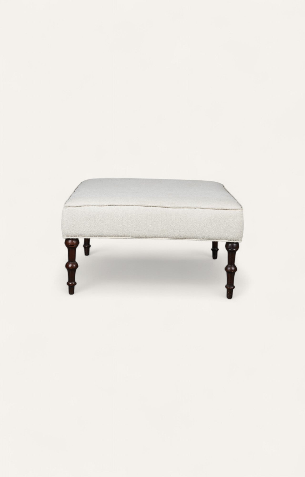 Traditional Ottoman with Cream Upholstery and Dark Turned Legs
