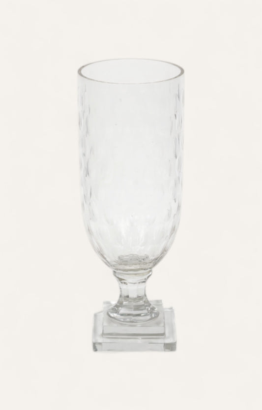 Tall hammered glass candle stand on a clear square base