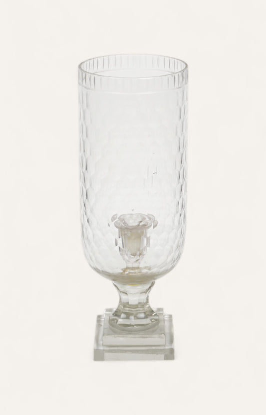 Tall ribbed glass hurricane candle stand on a layered base