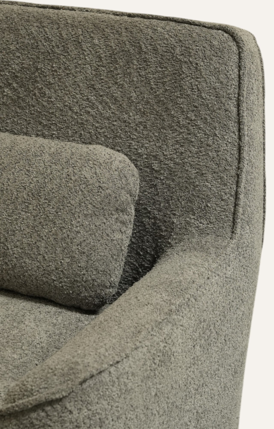 Grey colour bouclé lounge chair with a soft matching cushion 