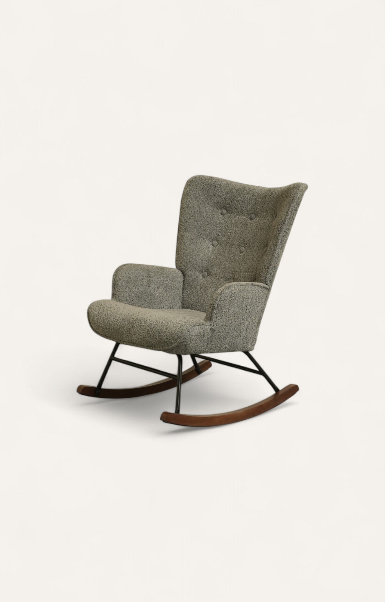 Rocking chair upholstered in soft grey boucle fabric with a light rubber wood frame and black iron legs.