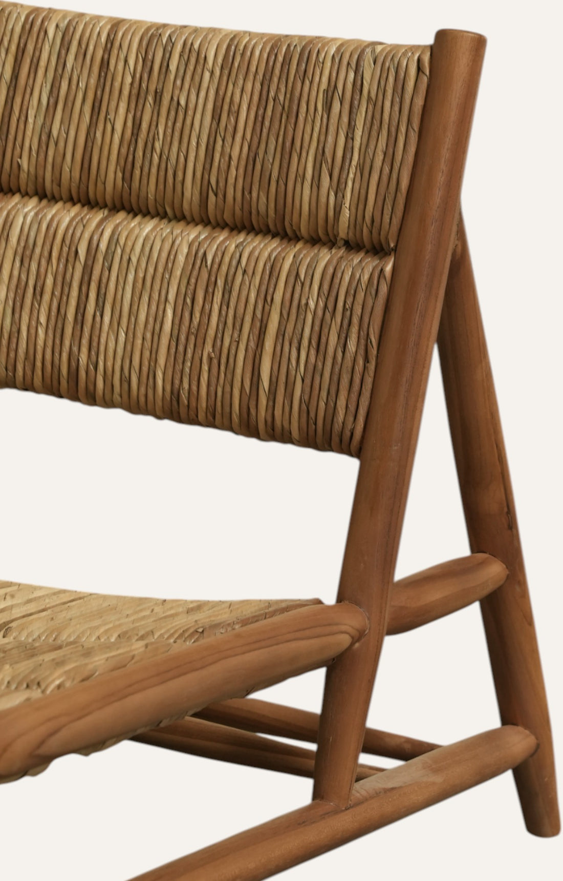 Low-slung chair made of teak wood with a hand-woven natural twisted pandan leaf seat and back.
