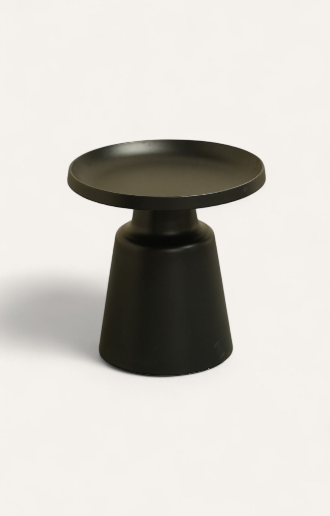 Set of two round nesting tables made of iron with black enameled coating.