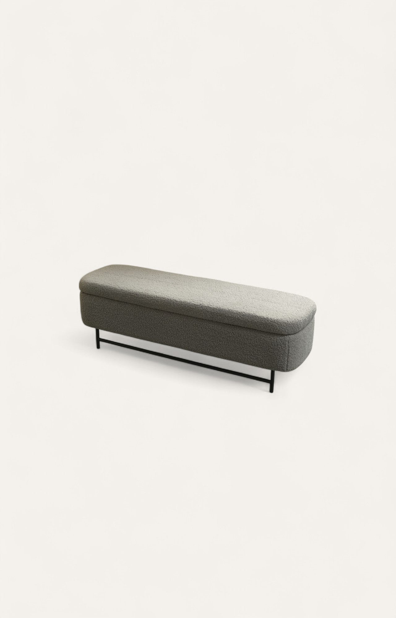 Charcoal grey bouclé fabric bench with curved arms, steel legs and covered storage space.