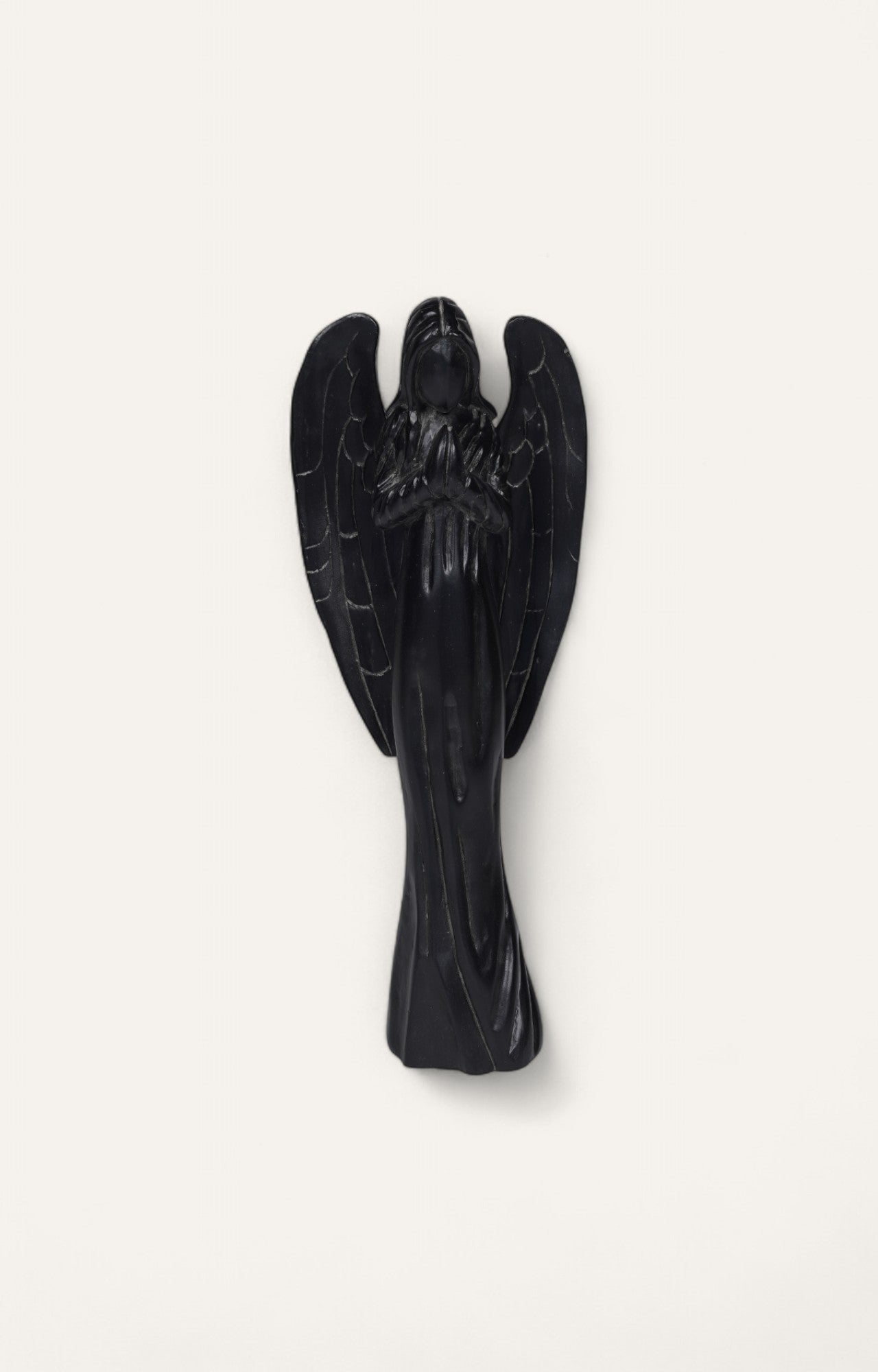  Black-finished teak wood angel sculpture in prayer pose.