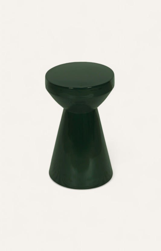 Dark green sculptural metal side table for multiple uses.
