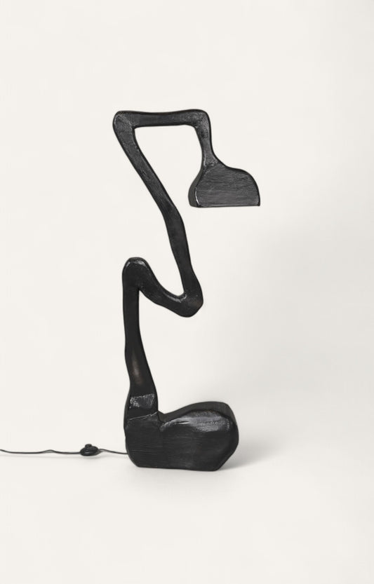 Modern sculptural floor lamp in black finish with mushroom-inspired wooden base.