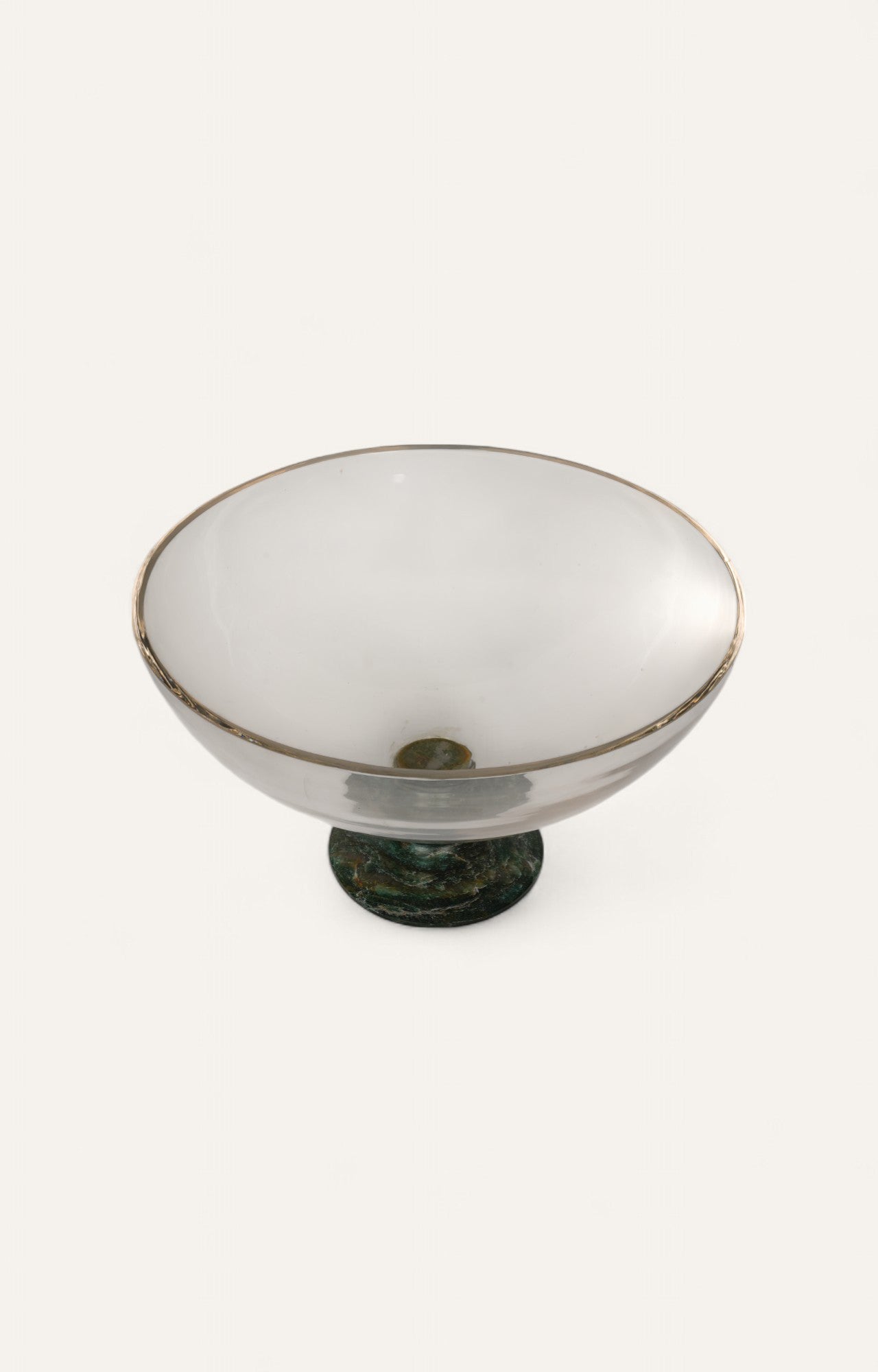 Vintage-style glass fruit bowl with green enamel foot and clear curved top.