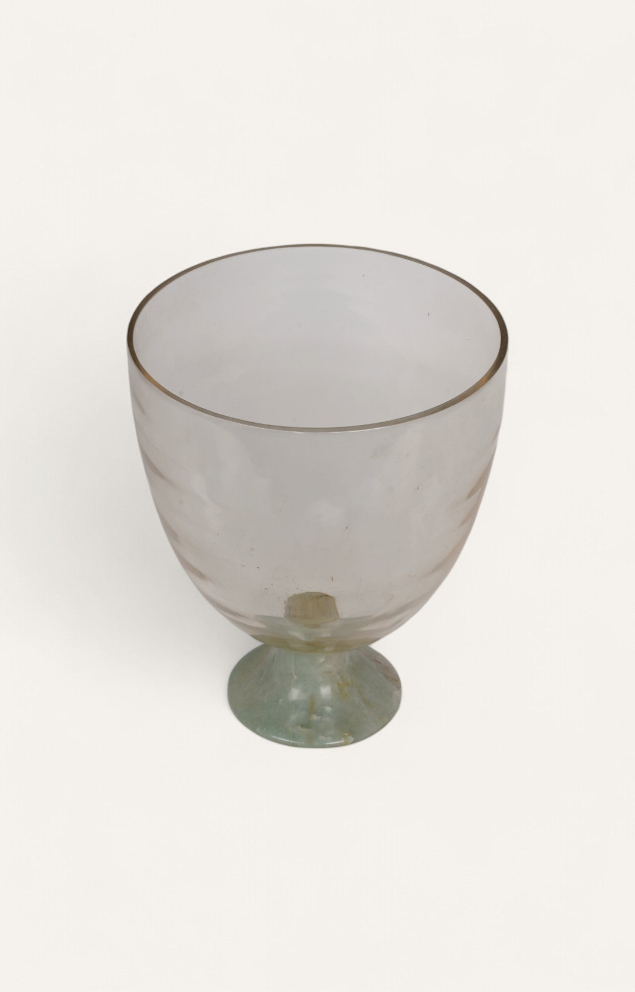  Footed round glass vase or candle stand with pale green quartz base.
